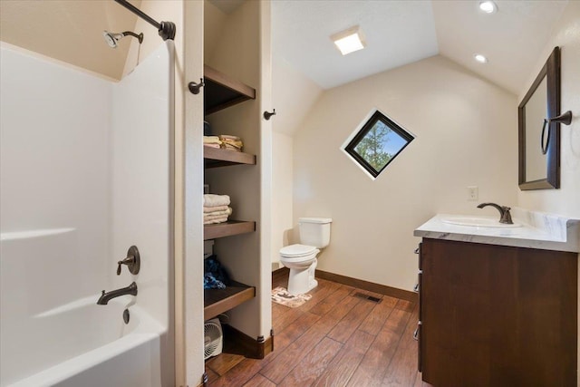 11132 Bogey Cir, Lead, SD 57754 - full bathroom featuring toilet, wood-type flooring, vanity, lofted ceiling, and recessed lighting