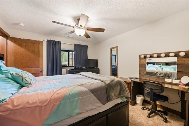 11132 Bogey Cir, Lead, SD 57754 - bedroom featuring carpet floors, an office area, a textured ceiling, and ceiling fan