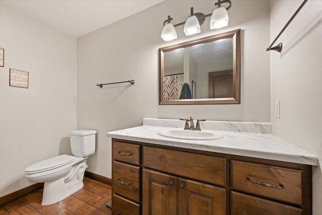 11132 Bogey Cir, Lead, SD 57754 - full bath featuring toilet, vanity, baseboards, and wood finished floors