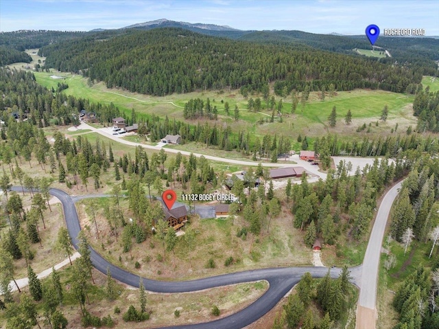 11132 Bogey Cir, Lead, SD 57754 - aerial view of property and surrounding area featuring a heavily wooded area and mountains