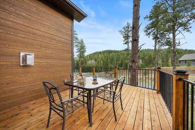 11132 Bogey Cir, Lead, SD 57754 - wooden deck featuring outdoor dining space and a view of trees