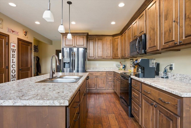 11132 Bogey Cir, Lead, SD 57754 - kitchen featuring stainless steel appliances, a sink, light countertops, brown cabinetry, and recessed lighting