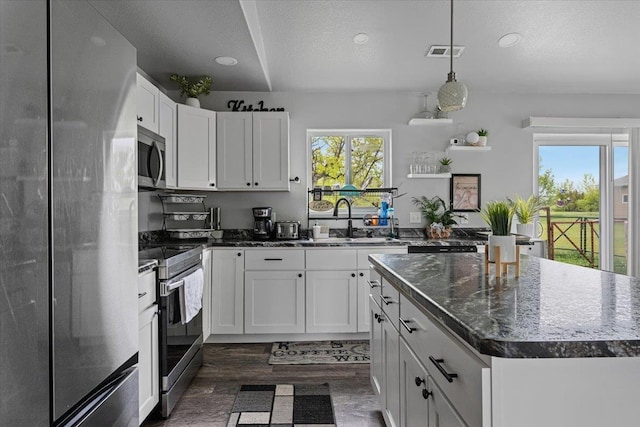 1430 Dacar St, Belle Fourche, SD 57717 - kitchen featuring stainless steel appliances, a sink, dark wood finished floors, healthy amount of natural light, and recessed lighting