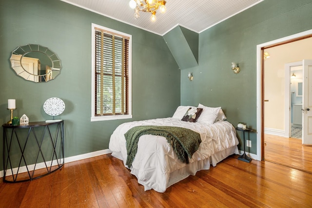 211 Milliken St, Lead, SD 57754 - bedroom featuring wood-type flooring, baseboards, and a chandelier