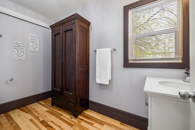 211 Milliken St, Lead, SD 57754 - bathroom featuring wood finished floors, baseboards, and vanity