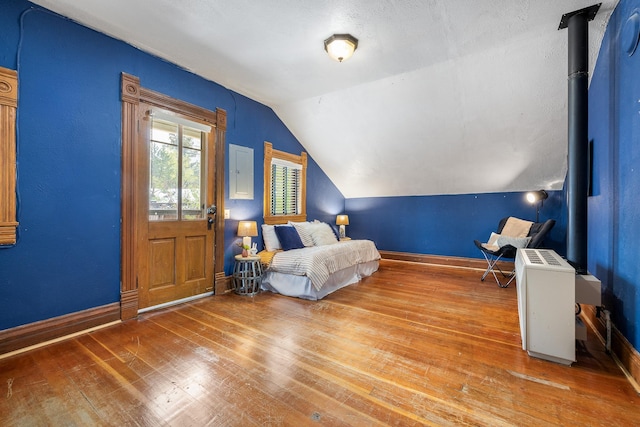 211 Milliken St, Lead, SD 57754 - living area featuring wood-type flooring, vaulted ceiling, baseboards, and electric panel