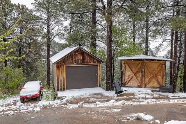 211 Milliken St, Lead, SD 57754 - snow covered garage with a detached garage