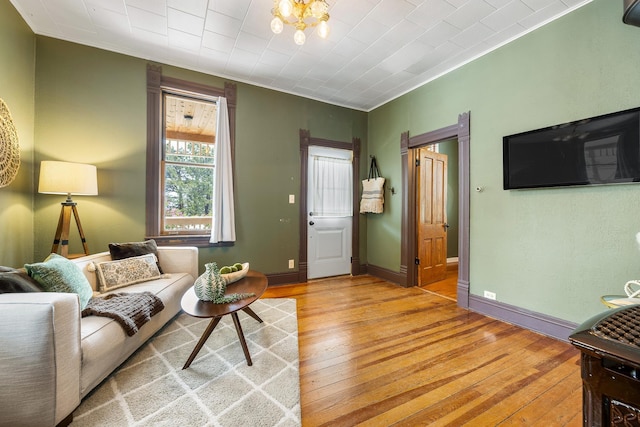 211 Milliken St, Lead, SD 57754 - living area featuring wood-type flooring, a chandelier, and baseboards