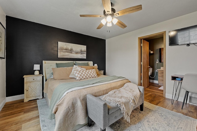 7350 Brighton St, Summerset, SD 57718 - bedroom with baseboards, light wood-style flooring, a ceiling fan, and an accent wall