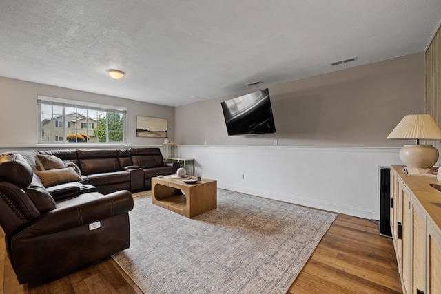 7350 Brighton St, Summerset, SD 57718 - living room with wood finished floors, a textured ceiling, and baseboards