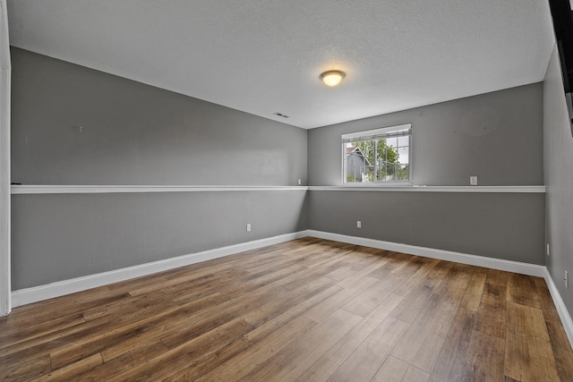 7350 Brighton St, Summerset, SD 57718 - spare room with hardwood / wood-style floors, baseboards, and a textured ceiling