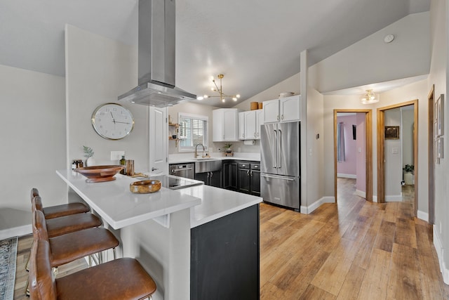 7350 Brighton St, Summerset, SD 57718 - kitchen with stainless steel appliances, exhaust hood, lofted ceiling, a kitchen breakfast bar, and a peninsula