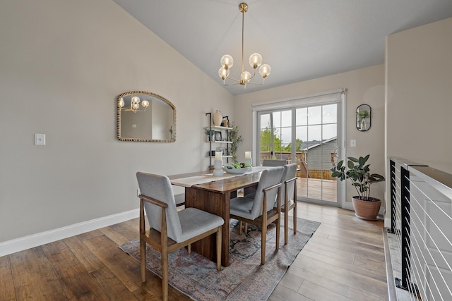 7350 Brighton St, Summerset, SD 57718 - dining space featuring a chandelier, light wood-style flooring, lofted ceiling, and baseboards