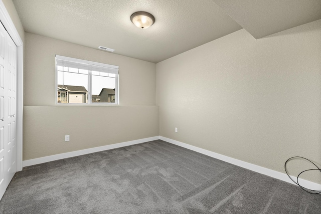 655 Bomber Way, Box Elder, SD 57719 - unfurnished bedroom featuring a closet, carpet, a textured ceiling, and baseboards