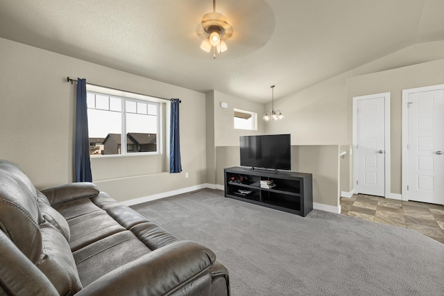 655 Bomber Way, Box Elder, SD 57719 - carpeted living room with a chandelier, vaulted ceiling, a ceiling fan, and baseboards
