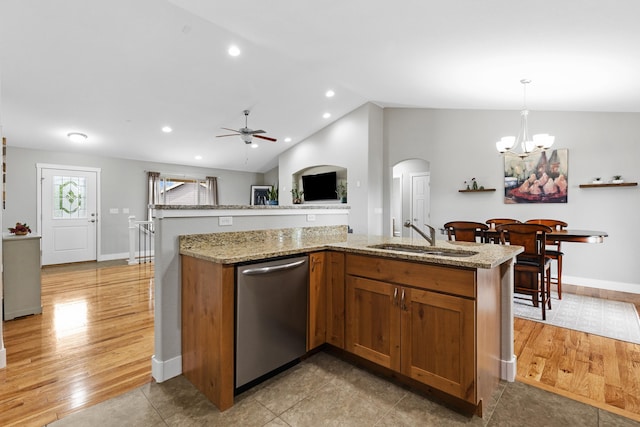 6212 Poppy Ct, Rapid City, SD 57702 - kitchen with stainless steel dishwasher, a sink, a chandelier, arched walkways, and lofted ceiling