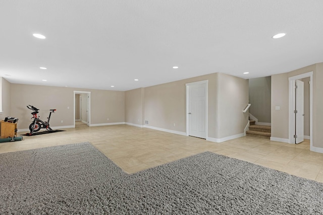6212 Poppy Ct, Rapid City, SD 57702 - below grade area featuring tile patterned flooring, recessed lighting, stairway, and baseboards