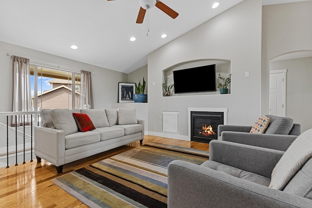 6212 Poppy Ct, Rapid City, SD 57702 - living room featuring lofted ceiling, wood finished floors, recessed lighting, a ceiling fan, and arched walkways