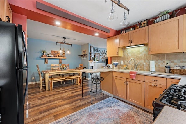30 Adams St, Deadwood, SD 57732 - kitchen with black appliances, light countertops, a sink, light wood finished floors, and decorative backsplash