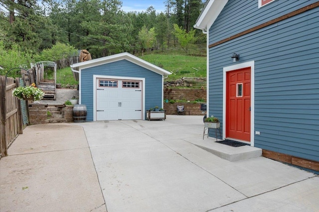 30 Adams St, Deadwood, SD 57732 - detached garage with driveway and a wooded view