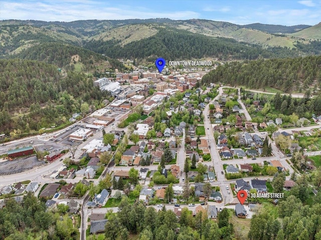 30 Adams St, Deadwood, SD 57732 - aerial view of property and surrounding area with a mountain backdrop and a heavily wooded area