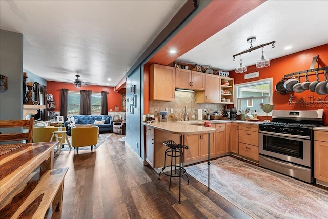30 Adams St, Deadwood, SD 57732 - kitchen with gas range, light countertops, open floor plan, wood finished floors, and healthy amount of natural light