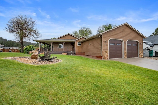 2315 Palisades Loop, Sturgis, SD 57785 - view of front of property featuring covered porch, a front lawn, an attached garage, and concrete driveway