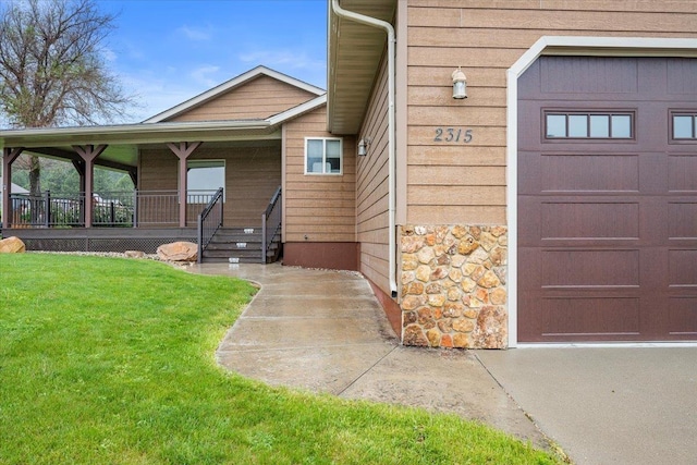 2315 Palisades Loop, Sturgis, SD 57785 - view of exterior entry featuring stone siding, a yard, and a porch