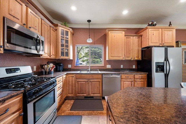 2315 Palisades Loop, Sturgis, SD 57785 - kitchen featuring stainless steel appliances, a sink, dark countertops, glass insert cabinets, and hanging light fixtures