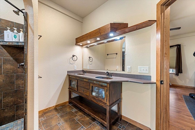 2315 Palisades Loop, Sturgis, SD 57785 - bathroom with double vanity, baseboards, and a shower