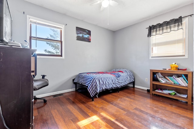 2045 12th Ave, Belle Fourche, SD 57717 - bedroom featuring wood finished floors, baseboards, and a ceiling fan