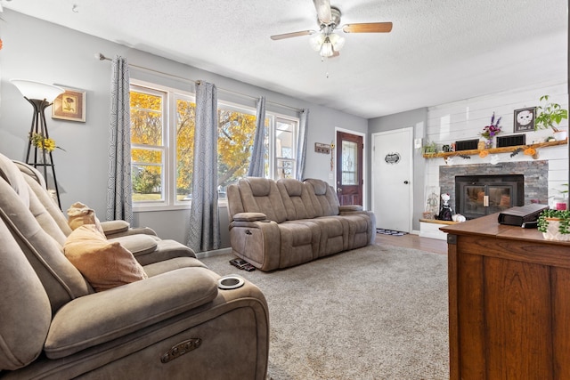 2045 12th Ave, Belle Fourche, SD 57717 - living area featuring a ceiling fan, a textured ceiling, and a fireplace