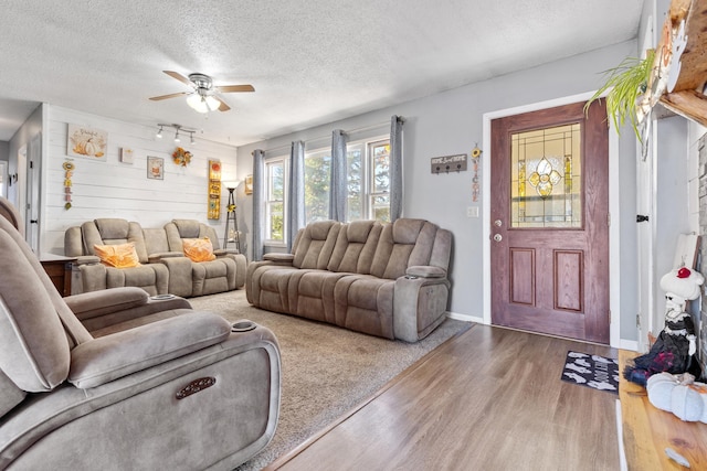 2045 12th Ave, Belle Fourche, SD 57717 - living area with wood finished floors, ceiling fan, a textured ceiling, and baseboards