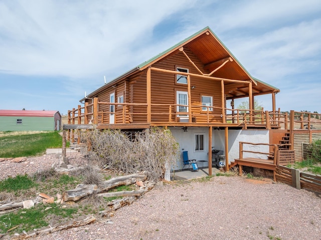 28013 Cascade Rd, Hot Springs, SD 57747 - back of property with log siding, a deck, and a patio area
