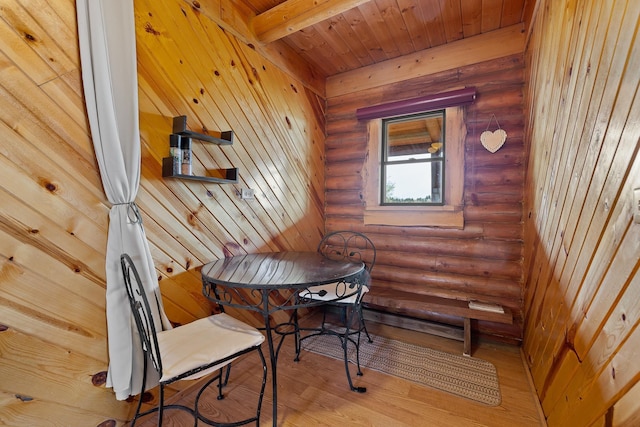 28013 Cascade Rd, Hot Springs, SD 57747 - dining room featuring rustic walls, light wood-type flooring, and wood ceiling with exposed beams