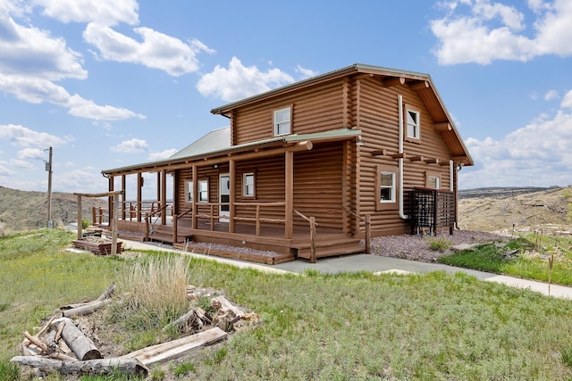 28013 Cascade Rd, Hot Springs, SD 57747 - view of property exterior with log siding, metal roof, and a deck