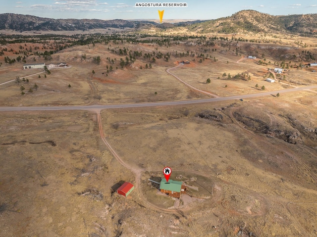 28013 Cascade Rd, Hot Springs, SD 57747 - aerial view of property and surrounding area featuring a mountainous background, rural landscape, and a desert landscape