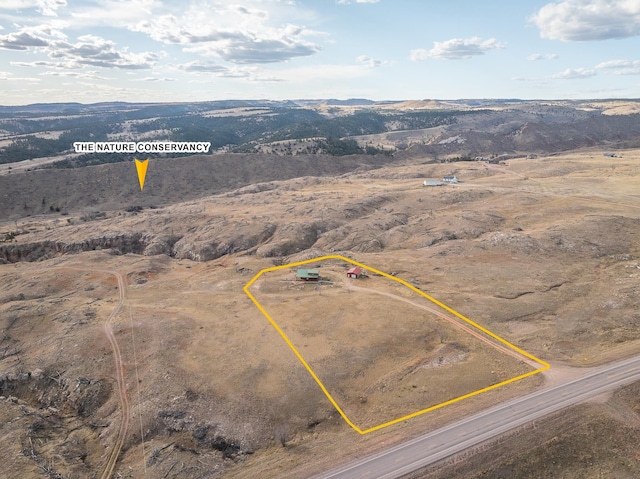 28013 Cascade Rd, Hot Springs, SD 57747 - aerial view of sparsely populated area featuring property boundaries highlighted, a mountainous background, and a desert landscape