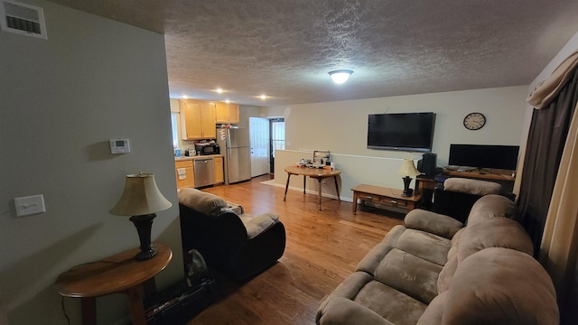 102 10th Ave, Belle Fourche, SD 57717 - living area with a textured ceiling and light wood finished floors