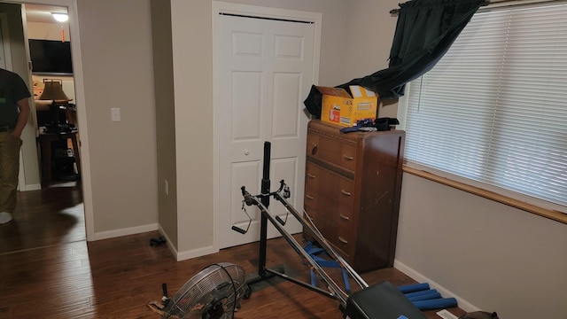 102 10th Ave, Belle Fourche, SD 57717 - exercise area with baseboards and dark wood-type flooring