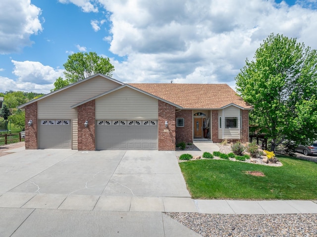 342 Enchantment Rd, Rapid City, SD 57701 - ranch-style home with an attached garage, a front lawn, driveway, and brick siding