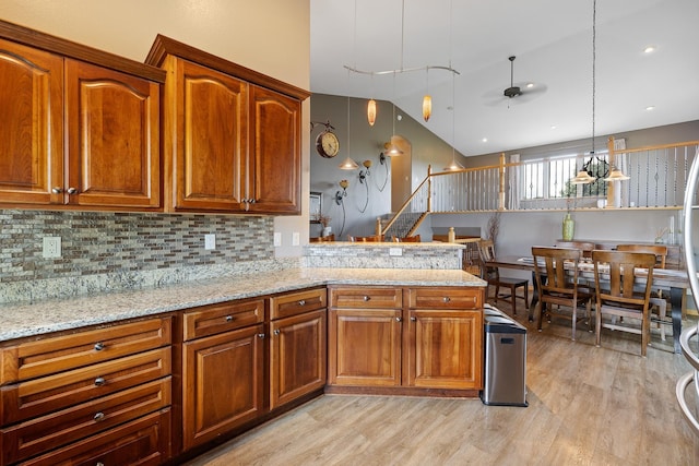 342 Enchantment Rd, Rapid City, SD 57701 - kitchen with light wood-style flooring, a ceiling fan, tasteful backsplash, and brown cabinetry