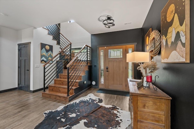 3135 American Eagle Rd, Spearfish, SD 57783 - entrance foyer with stairway, wood finished floors, and baseboards