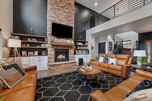 3135 American Eagle Rd, Spearfish, SD 57783 - living area with a high ceiling, stairs, a fireplace, and wood finished floors