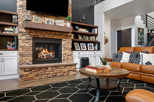 3135 American Eagle Rd, Spearfish, SD 57783 - living room with dark wood-style floors, a fireplace, and stairway