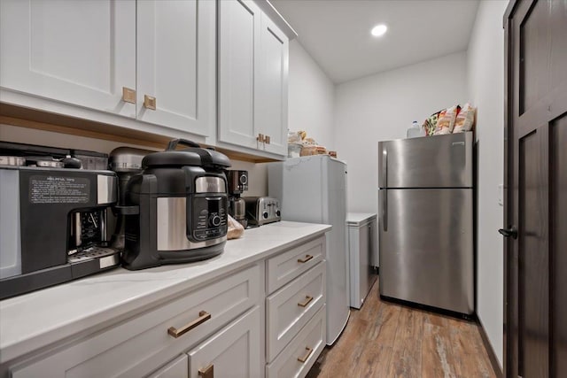 3135 American Eagle Rd, Spearfish, SD 57783 - kitchen with freestanding refrigerator, light wood-type flooring, white cabinets, and recessed lighting