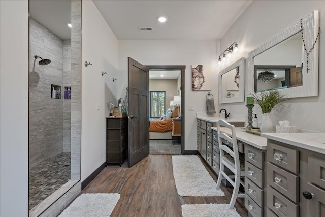 3135 American Eagle Rd, Spearfish, SD 57783 - full bathroom with ensuite bathroom, a walk in shower, double vanity, and wood finished floors