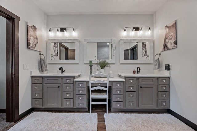 3135 American Eagle Rd, Spearfish, SD 57783 - full bath with two vanities, wood finished floors, and baseboards