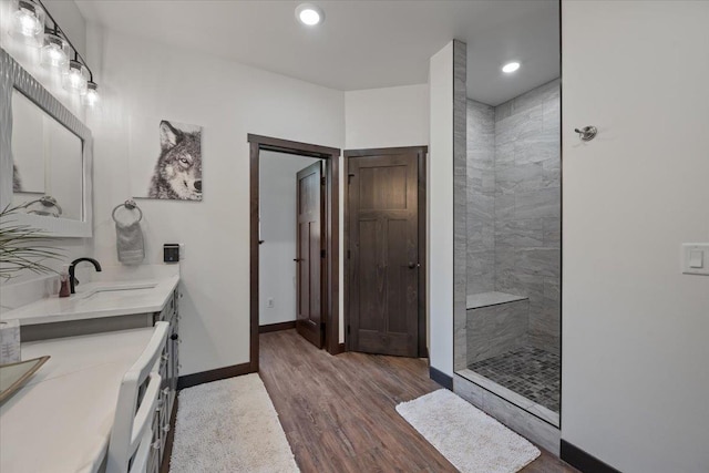 3135 American Eagle Rd, Spearfish, SD 57783 - full bathroom with walk in shower, vanity, wood finished floors, baseboards, and recessed lighting
