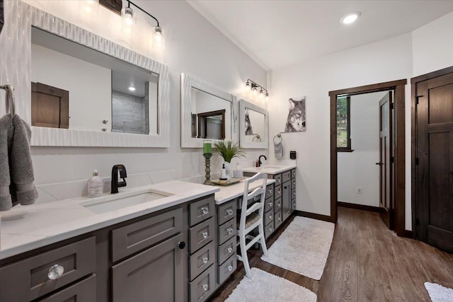 3135 American Eagle Rd, Spearfish, SD 57783 - bathroom with double vanity, wood finished floors, and baseboards